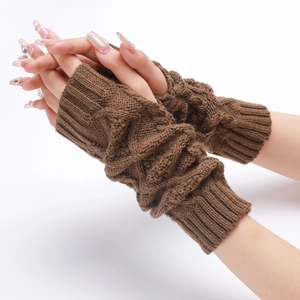 Detail of brown knitted fingerless gloves showing cable knit texture and ribbed cuffs