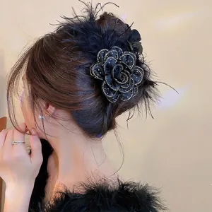Elegant black fabric flower hair claw clip with delicate feathers and rhinestones