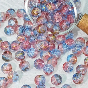Close-up of 10mm pink and blue gradient glass beads with gold crackle for DIY jewelry