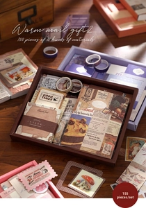 Top-down view of a 155-piece vintage journal kit including washi tapes and paper ephemera