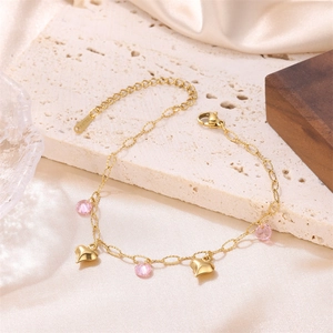 Elegant 18K gold plated stainless steel heart charm bracelet with pink crystals on silk