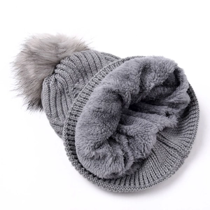 Solid grey knitted beanie for women featuring diamond patterns and faux fur pompom