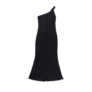 Close-up of black sequined fabric on a one-shoulder evening gown with shimmering details