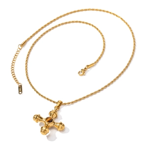 Close-up of 18K gold stainless steel cross pendant with brown tiger eye stone and lobster clasp
