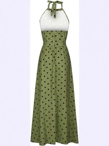 Green sleeveless maxi dress with black polka dots featuring halter neck and backless design