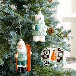 Sage green ceramic Christmas ornaments set featuring Santa, polar bear, and vintage camper