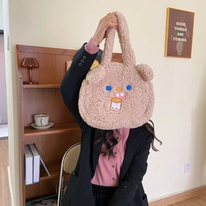Detail of cute lamb wool tote bag featuring an embroidered bear drinking milk tea