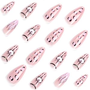 Pink long stiletto press-on nails with evil eye patterns and snake print rhinestone accents