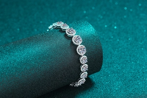 Macro shot of silver halo bracelet featuring round moissanite stones on a stand