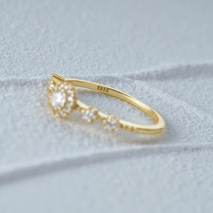 Macro detail of S925 sterling silver hallmark and diamond halo setting on gold ring