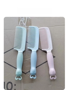 Detail view of three colorful cartoon plastic fine-toothed combs for girls