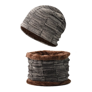 Detail of winter knitted hat and neck warmer set with thick brown fleece lining