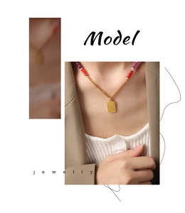 Detail of Chinese style necklace with colorful beads and engraved lucky charm pendant