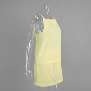 Side view of yellow two-piece set featuring a strapless crop top and matching mini skirt