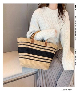 Detail of striped woven tote bag featuring vintage bamboo handles and textured cotton fabric