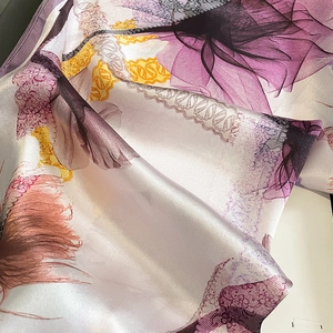 Elegant silk scarf for women featuring purple floral patterns and satin texture finish