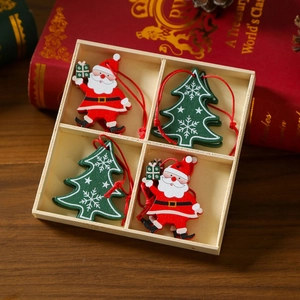 Close-up of 4-piece wooden Christmas ornaments with Santa and tree in a partitioned box