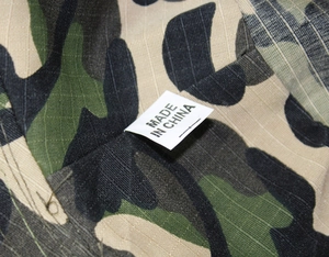 Close-up of camo boonie hat fabric showing Made in China label and durable stitching