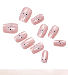 Detailed view of pink cat-themed reusable press-on nails with cute hand-painted patterns