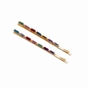 Fashionable gold hair clips set with multi-colored rectangular rhinestones on white background