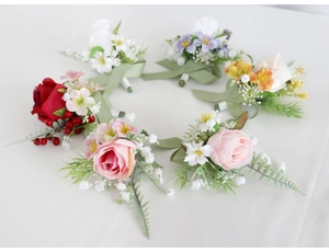 Detailed close-up showing assorted silk rose boutonnières in vibrant multiple colors
