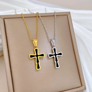 Titanium steel cross pendant necklaces in gold and silver finish on silk background
