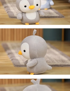 Detailed views showing the front, side and back of this soft grey penguin plush toy