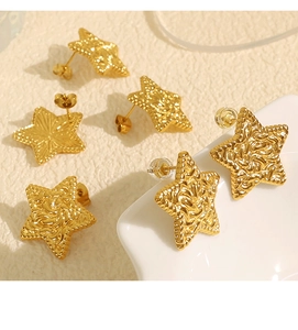 Detail of three pairs of gold star earrings with unique wavy lava texture surface