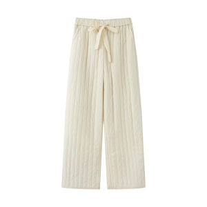 Detail of cream quilted thermal pants featuring elastic waist with drawstring bow detail