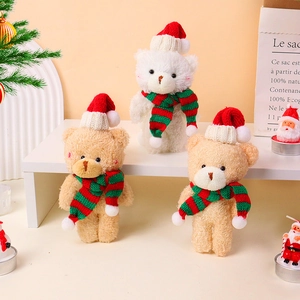 Three plush teddy bears with Christmas hats and striped scarves on a festive shelf