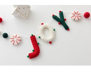Detail of wool felt JOY letters and peppermint ornaments on festive Christmas banner