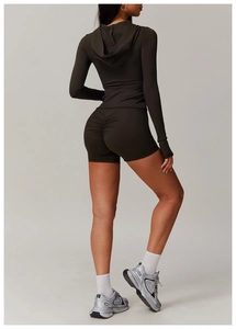Detail view of high-waisted scrunch butt yoga shorts and slim fit hoodie in dark brown