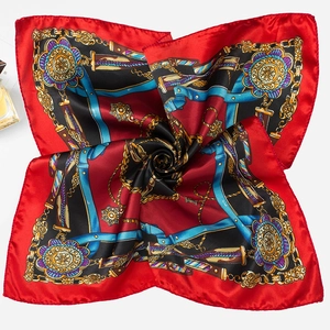 Close-up of red and blue satin square scarf with vintage golden chain and buckle print