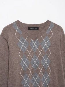 Macro detail of V-neckline and argyle pattern on brown wool blend knit sweater