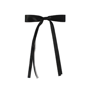 Detailed view of a sleek black satin ribbon bow hair clip on a white background
