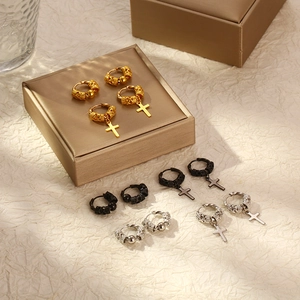 Detailed shot of stainless steel hoop earrings with dragon totem and cross charms in 3 colors