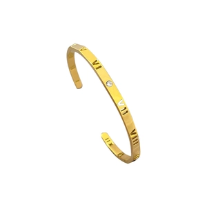 Gold stainless steel bangle with cutout Roman numerals and an embedded zircon crystal