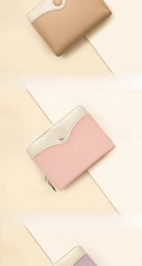 Detail of pink and purple bi-fold wallets with gold zippers and stylish snap buttons