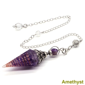 Macro shot of an Amethyst crystal pendulum with silver flower cap and decorative chain