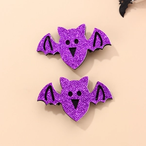Detail of pair of purple glitter bat hair clips with black outlines on pink backdrop