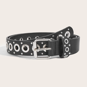 Punk style black leather belt with silver metal grommets and chain on beige background