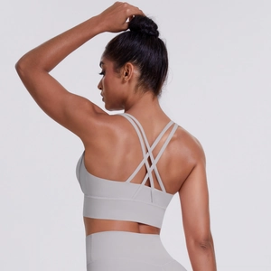 Close-up of light grey cross-back sports bra with elastic fabric and fine stitching detail
