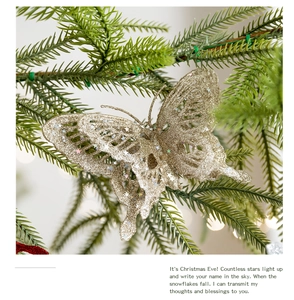 Close-up of golden glitter butterfly ornament with star sequins on a Christmas tree branch