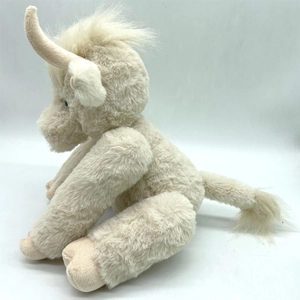 Close-up of beige Highland Cow plush toy showing long realistic fur texture and details
