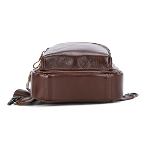Detailed bottom view of genuine leather chest bag showing wide base and brown leather texture