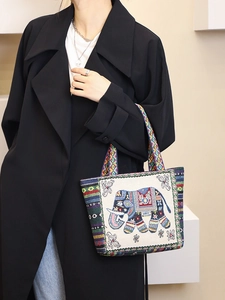 Ethnic style canvas tote bag featuring colorful elephant embroidery and fabric handles