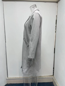 Side view of light grey mid-length wool coat with large lapel and side pocket