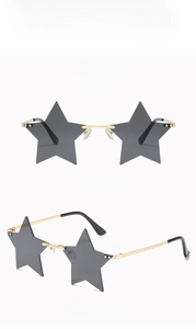 Detail view of star-shaped rimless sunglasses with gold metal frame and dark grey lenses