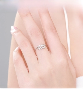 Detail of 925 sterling silver wave ring with sparkling pavé cubic zirconia