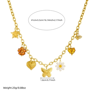 Gold stainless steel necklace with daisy and butterfly pendants in professional studio lighting